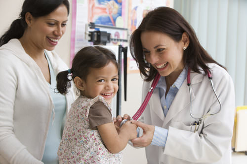 Physician examining child with mother. Physician examining child with mother.