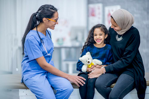 Physician examining child with mother.